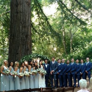 Bride and Groom wedding party lined up beneath trees at Sand Rock Farm