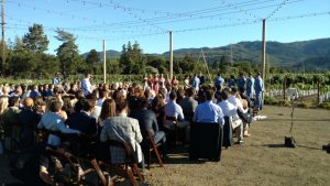 Wedding ceremony w/ view of Napa vineyards and hills as seen from the sound engineer's table in back