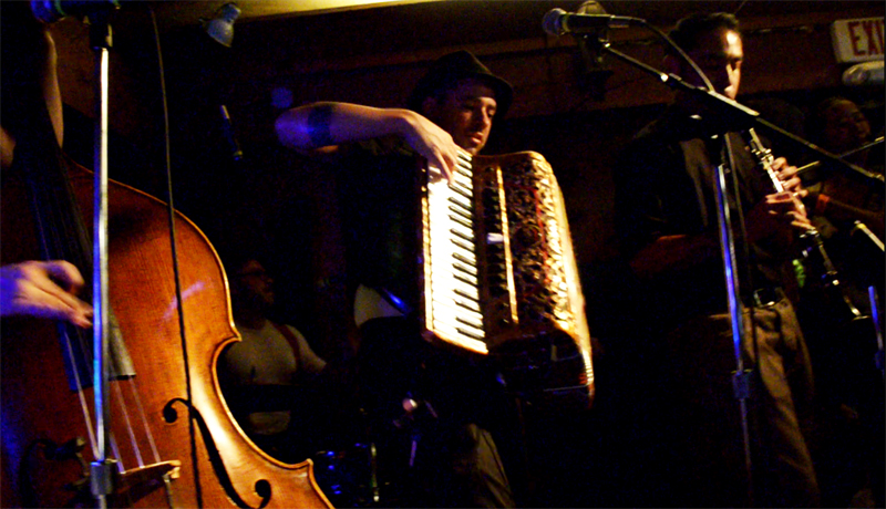 Trio performing with upright bass, accordian and clarinet